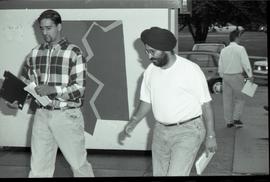 Communications Relations Opening Day 1991; two men walking past sign
