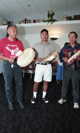 Three First Nations men playing instruments at the First Nations graduation [2 of 3 photographs]