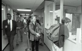 Communications Relations Opening Day 1991; student in front of registration desk as others walk p...