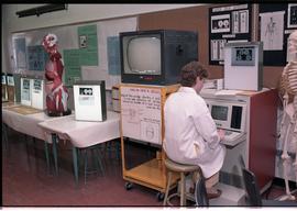 Open House 1986; student on computer by medical displays