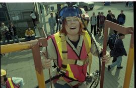 Open House 1998; woman climbing up ladder wearing gas mask