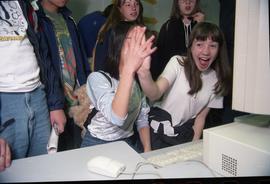 Open House 1998; two girls high fiving in front of computer [ photograph 2 of 2]