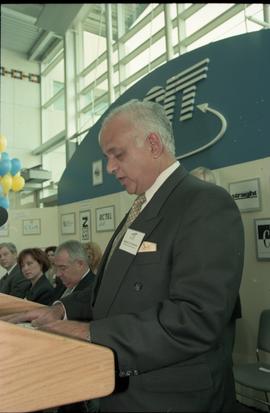 Open House 1998; older man recites speech behind podium on Open House BCIT stage [photograph 1 of...