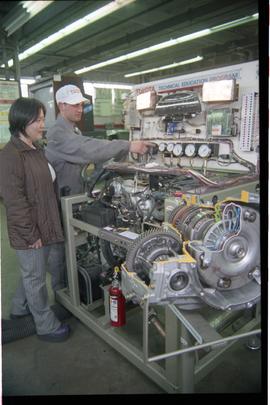 Open House 1998; man pointing at a gauge on the Toyota technical education program display in fro...