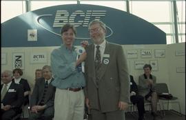 Open House 1998; student grinning with bearded man in suit holding first prize ribbon [photograph...