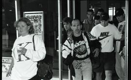 Communications Relations Opening Day 1991; people walking through glass doors [photograph 3 of 3]