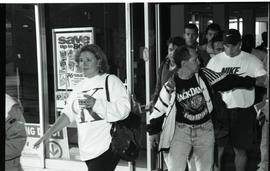 Communications Relations Opening Day 1991; people walking through glass doors [photograph 2 of  3]