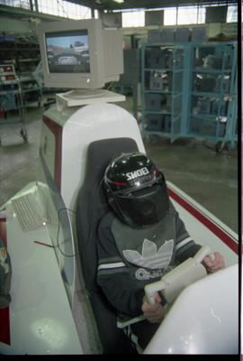 Open House 1998; child enjoying VR racing in simulated racing car