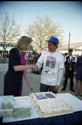 Open House 1992; man and woman shaking hands over cake